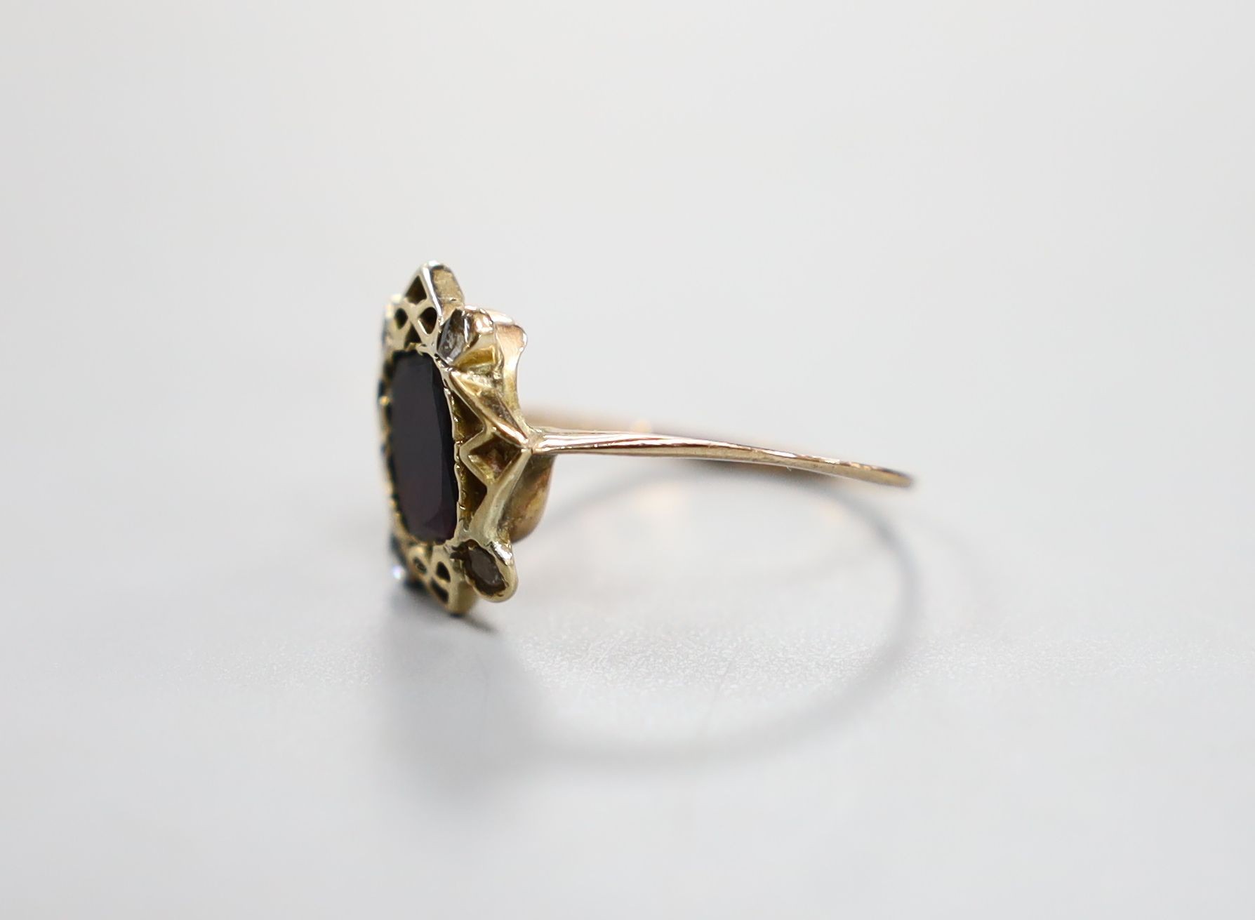 A 19th century yellow metal, garnet and four stone rose cut diamond set dress ring, size P/Q, gross 2.4 grams.
